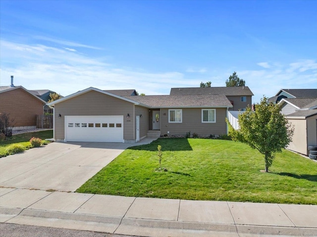 ranch-style home with a garage and a front lawn