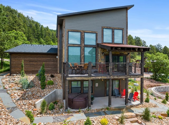 back of house with a balcony and a patio area