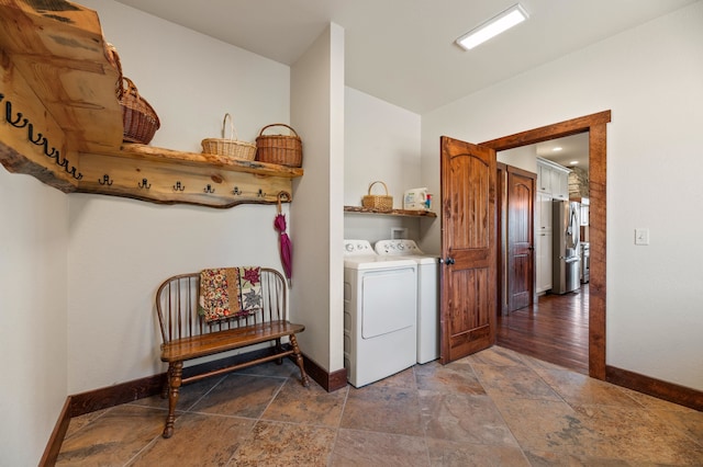 laundry room with dark hardwood / wood-style floors and washer and dryer