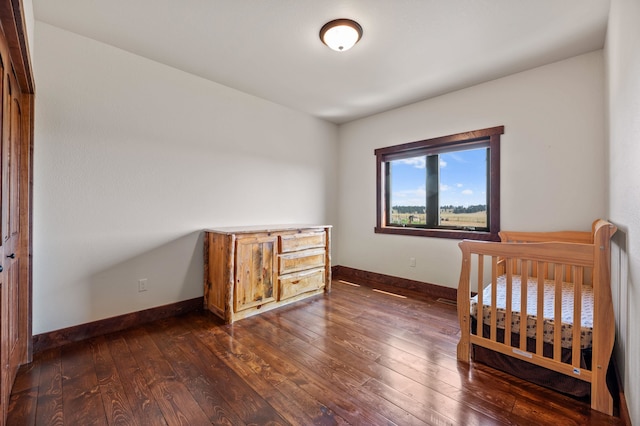 bedroom featuring dark wood-type flooring and a closet