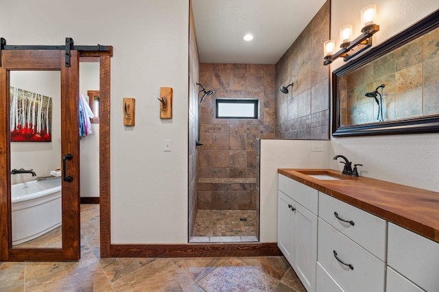 bathroom featuring tiled shower and vanity