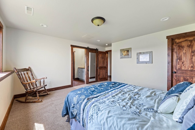 carpeted bedroom with a barn door