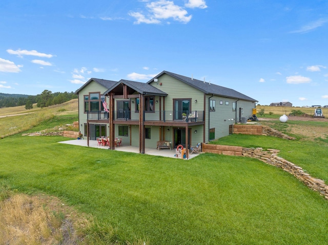 back of house with a patio, a balcony, and a lawn