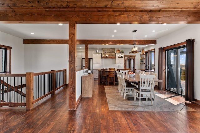 dining space featuring beam ceiling, wood ceiling, and dark hardwood / wood-style floors