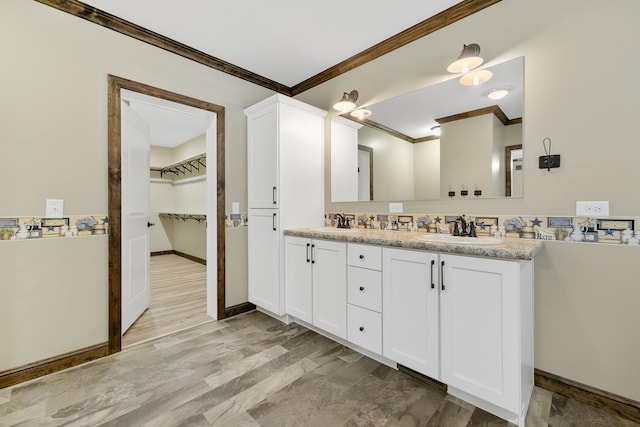 bathroom with crown molding, vanity, and wood-type flooring