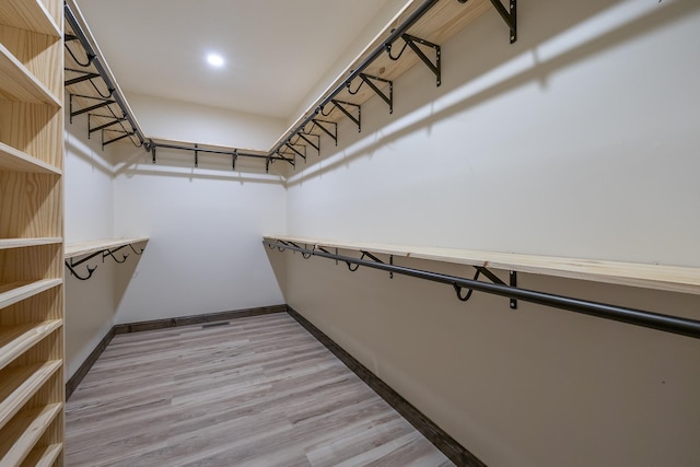 spacious closet featuring hardwood / wood-style floors