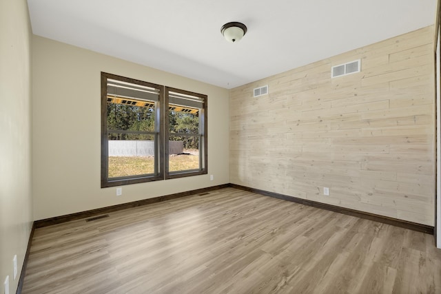 empty room with light hardwood / wood-style flooring