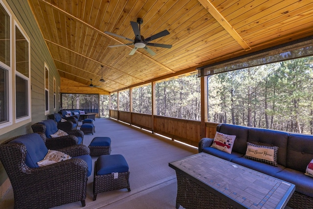 sunroom / solarium with ceiling fan, a wealth of natural light, vaulted ceiling, and wooden ceiling