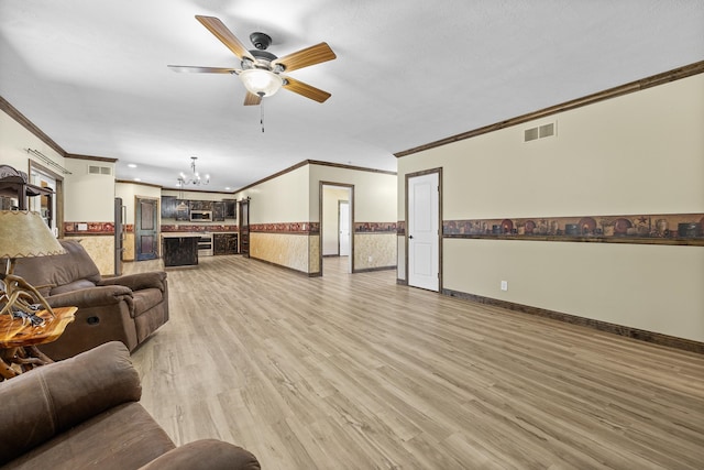 living room featuring ceiling fan with notable chandelier, crown molding, light wood-type flooring, and a textured ceiling