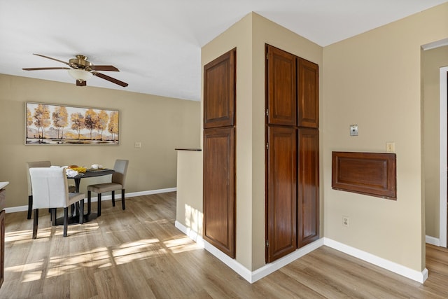 kitchen featuring ceiling fan and light hardwood / wood-style flooring