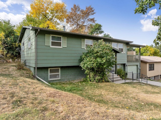 back of property featuring a balcony and a lawn