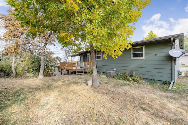 back of property featuring a wooden deck and central AC