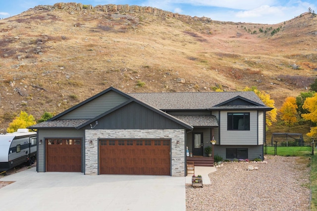 view of front facade with a garage and a mountain view