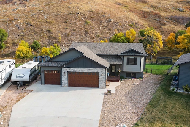 view of front of property with a garage and a front lawn