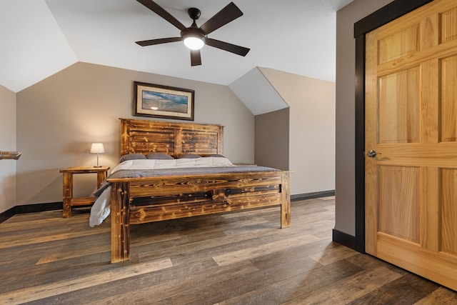 bedroom featuring vaulted ceiling, dark wood finished floors, a ceiling fan, and baseboards