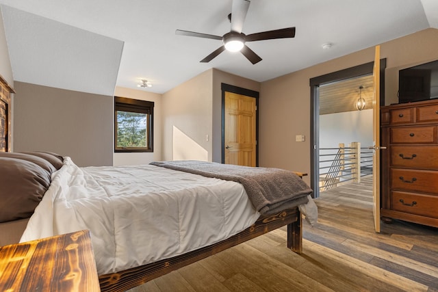 bedroom with vaulted ceiling, ceiling fan, and wood finished floors