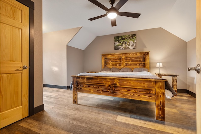 bedroom with lofted ceiling, a ceiling fan, baseboards, and wood finished floors