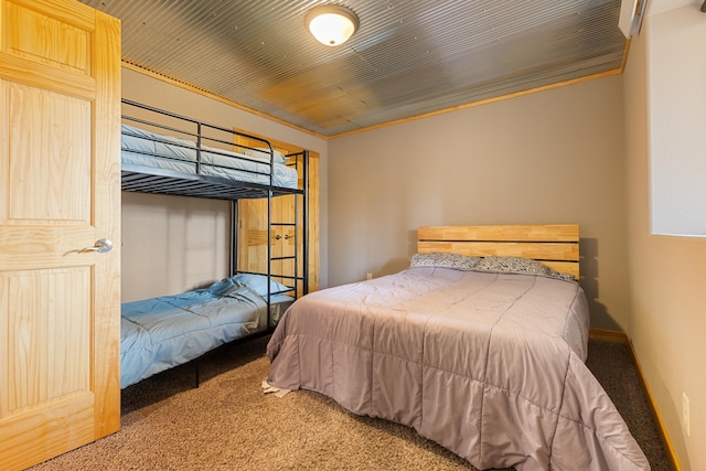 carpeted bedroom featuring wood ceiling and crown molding