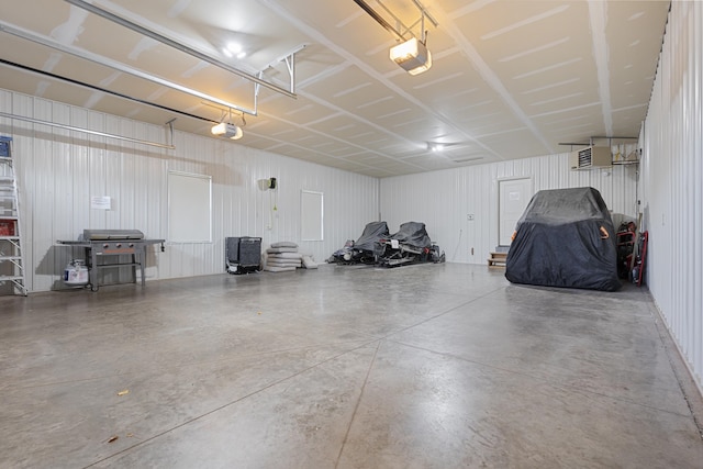 garage with a garage door opener and metal wall