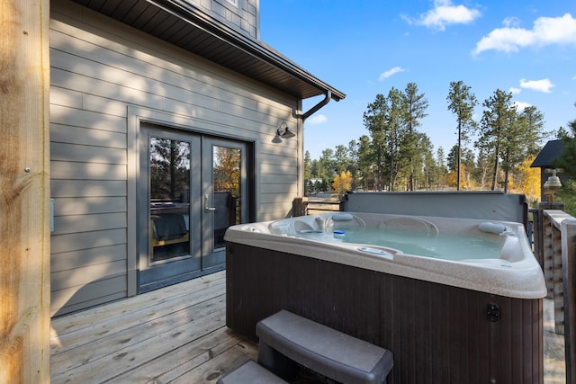 wooden deck with a hot tub