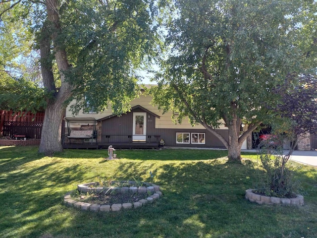 view of front of house with a front lawn and a deck