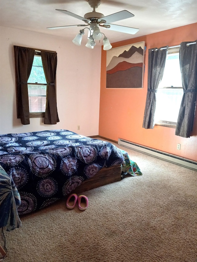 carpeted bedroom featuring baseboard heating and ceiling fan