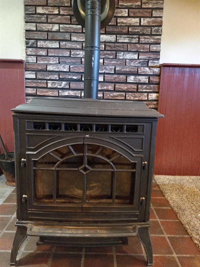 room details featuring a wood stove and wooden walls