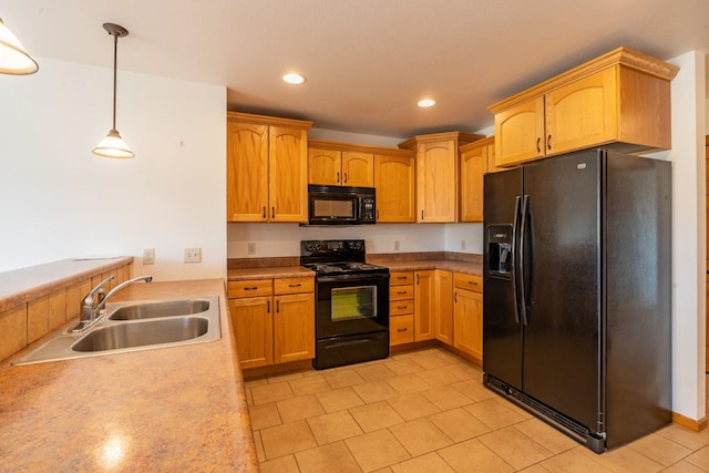 kitchen featuring hanging light fixtures, black appliances, and sink