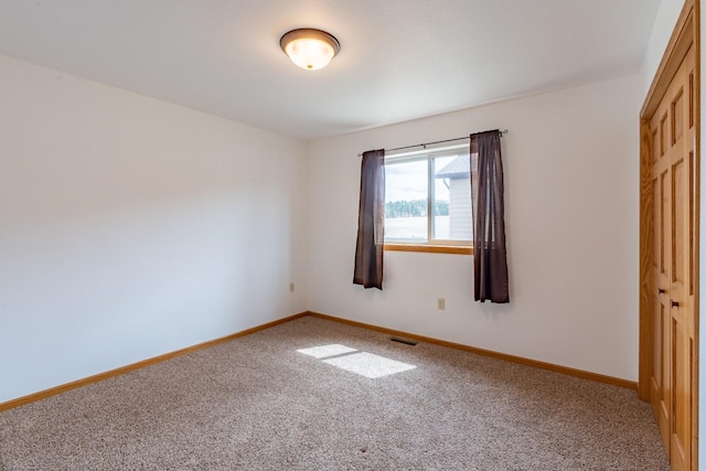 unfurnished bedroom featuring carpet floors and a closet