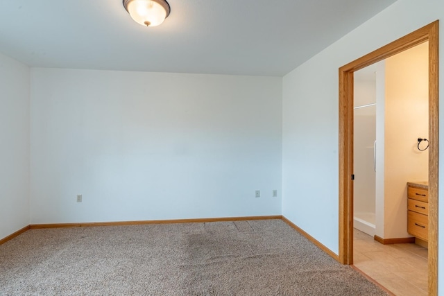 unfurnished bedroom featuring light carpet