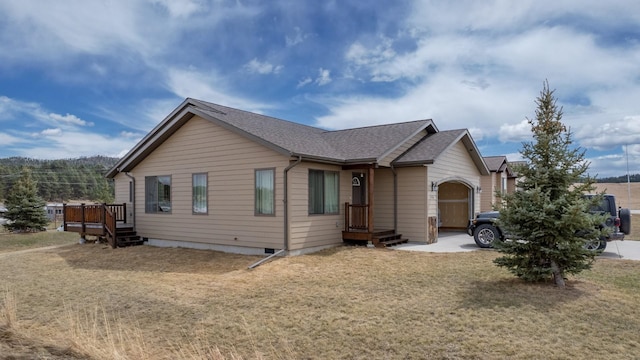 view of front of home with a garage and a front lawn