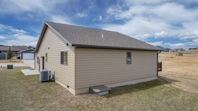 view of property exterior featuring a yard, central AC, and a garage