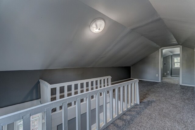 interior space featuring lofted ceiling and carpet flooring