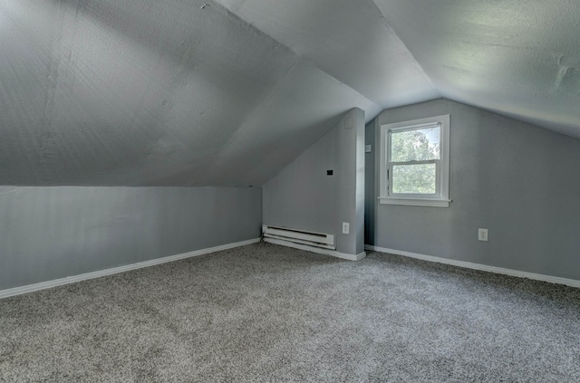 bonus room with lofted ceiling, carpet floors, a baseboard heating unit, and a textured ceiling