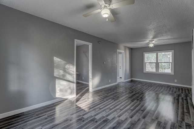 spare room with ceiling fan, a textured ceiling, and dark wood-type flooring