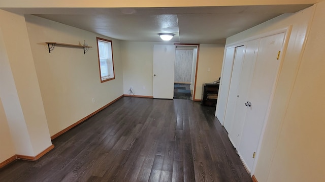 unfurnished room with dark hardwood / wood-style flooring