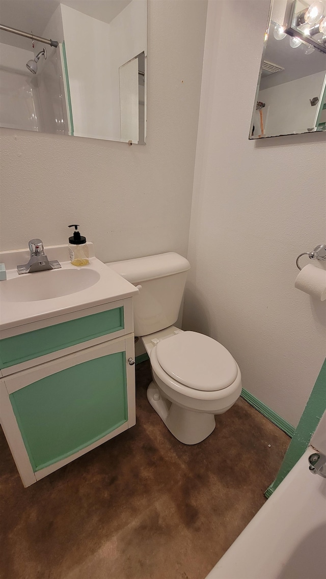 bathroom with concrete floors, vanity, and toilet