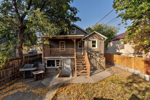 rear view of property featuring a patio area