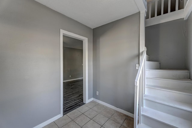 staircase with tile patterned floors