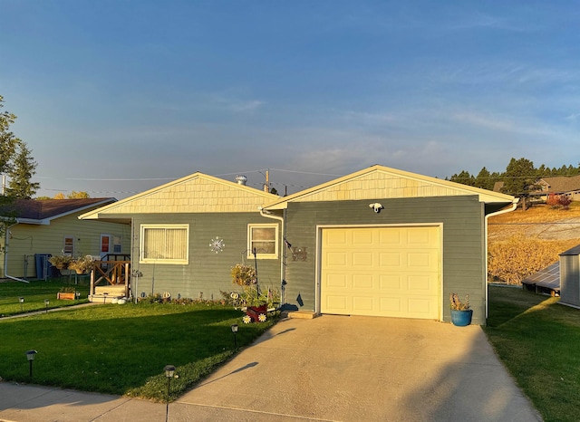 ranch-style home featuring a garage and a front lawn