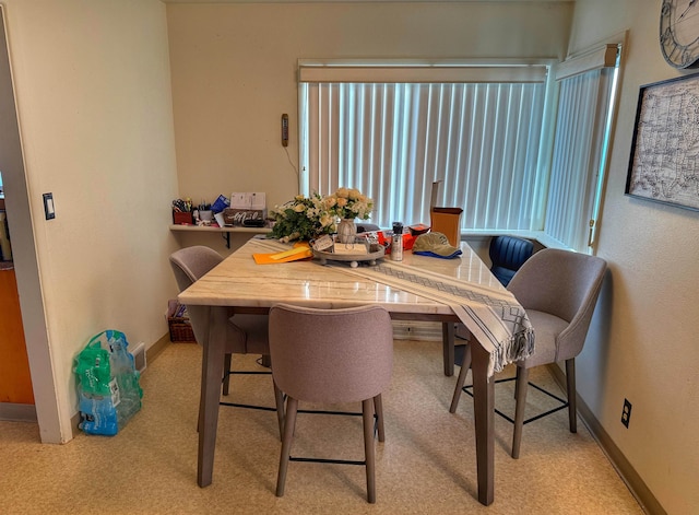 dining space with light carpet