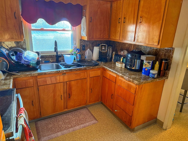 kitchen with decorative backsplash, sink, and stove