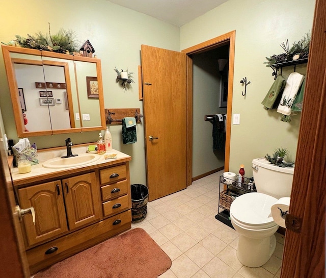 bathroom with vanity, toilet, and tile patterned floors