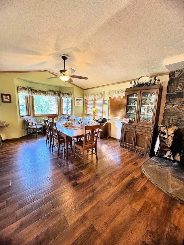 dining area featuring lofted ceiling, dark hardwood / wood-style floors, crown molding, a textured ceiling, and ceiling fan