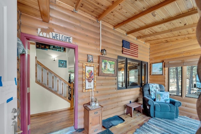 interior space with wood ceiling, hardwood / wood-style flooring, and rustic walls