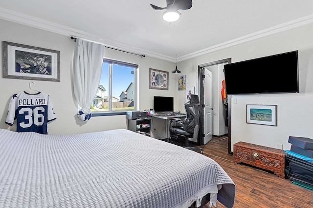 bedroom featuring ceiling fan, ornamental molding, and dark hardwood / wood-style floors