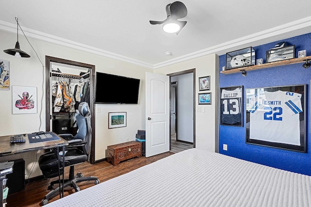 bedroom with ornamental molding, a closet, and dark hardwood / wood-style floors