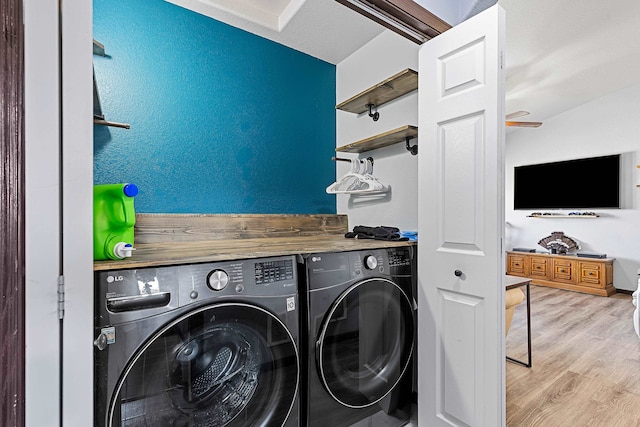 washroom featuring washer and clothes dryer and light hardwood / wood-style floors