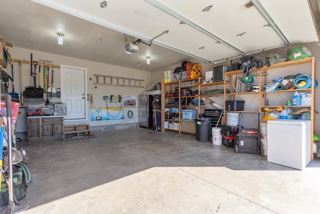 garage featuring a garage door opener and fridge