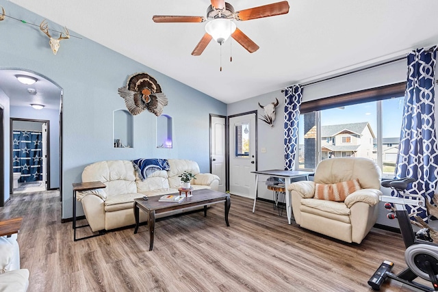 living room featuring ceiling fan, lofted ceiling, and hardwood / wood-style floors